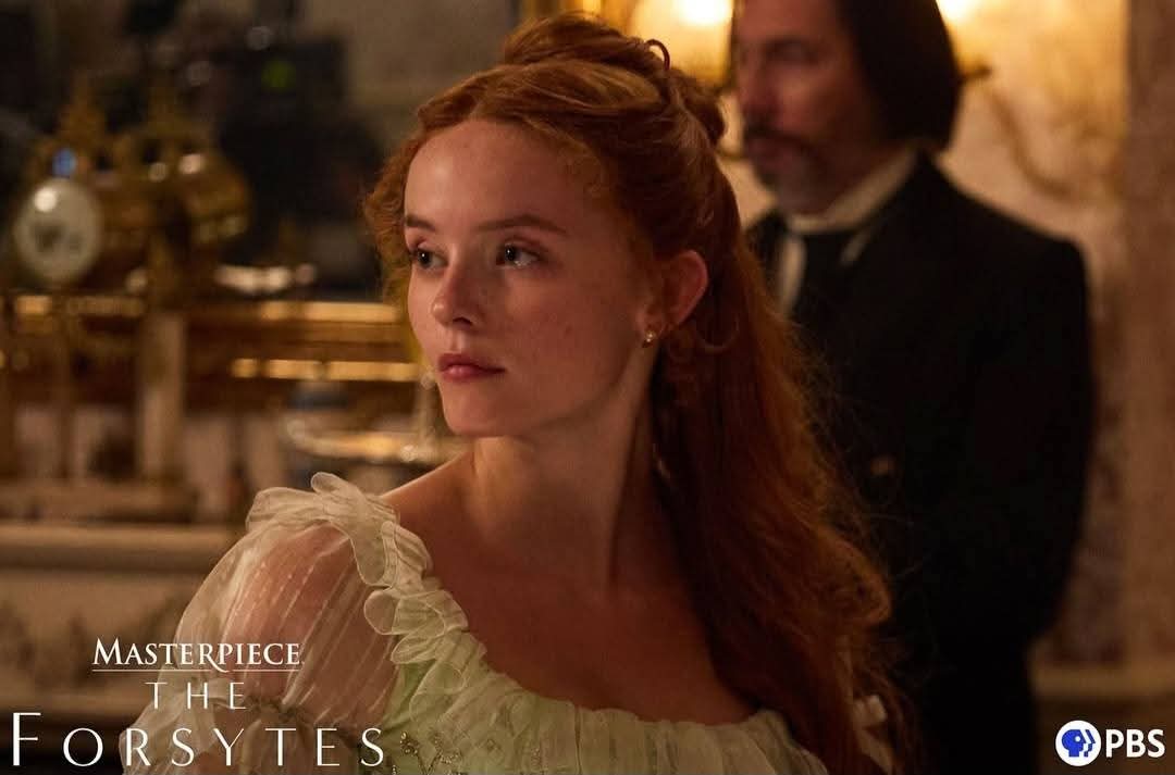 Mille Gibson a pretty red haired woman in a white dress