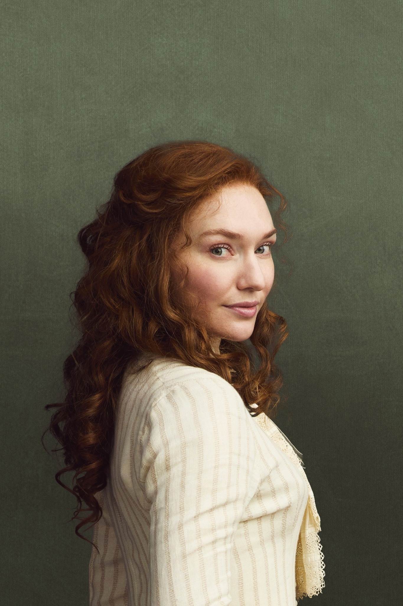 Red-haired young woman in a white dress