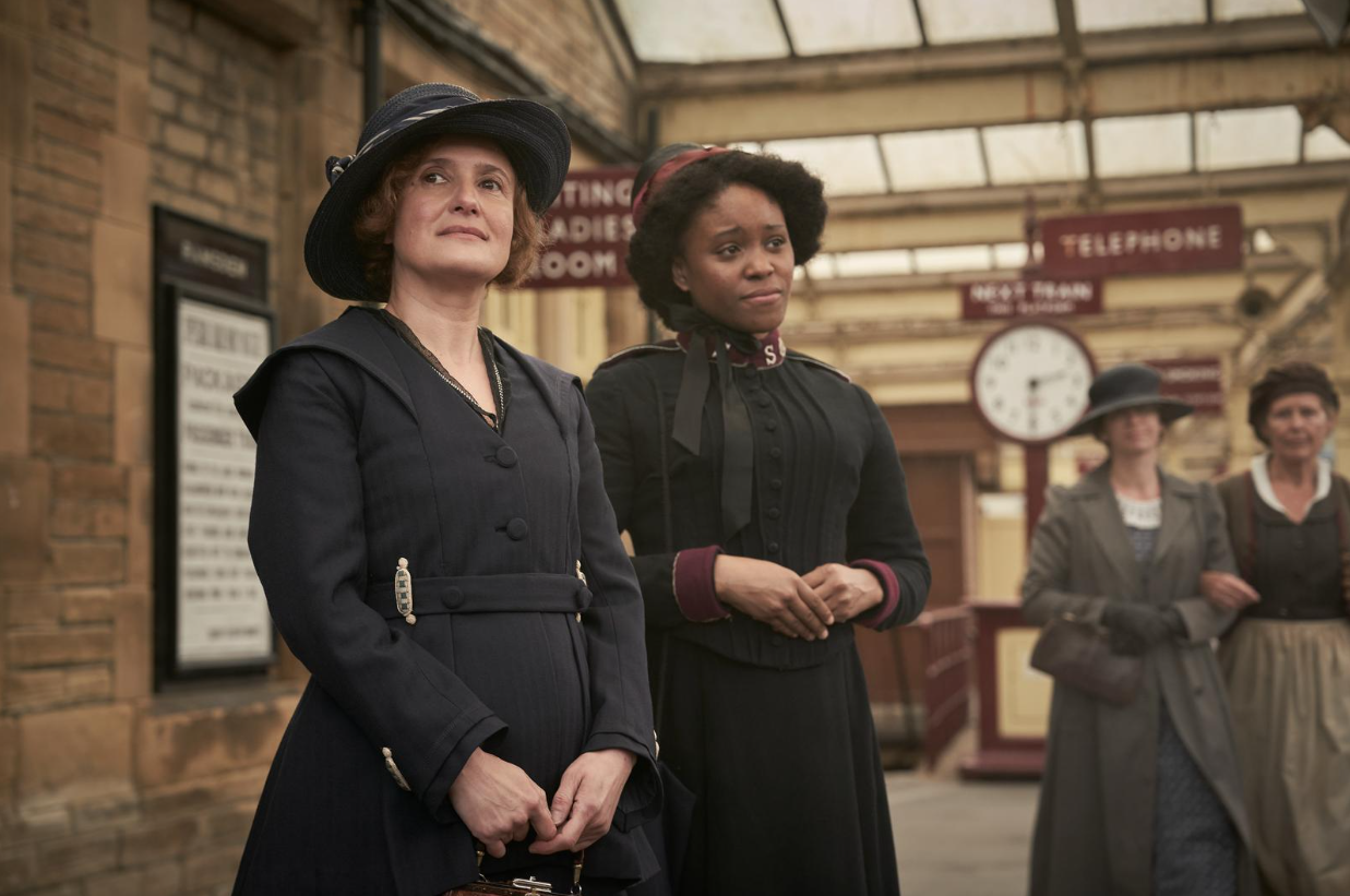 Two ladies waiting at a train station