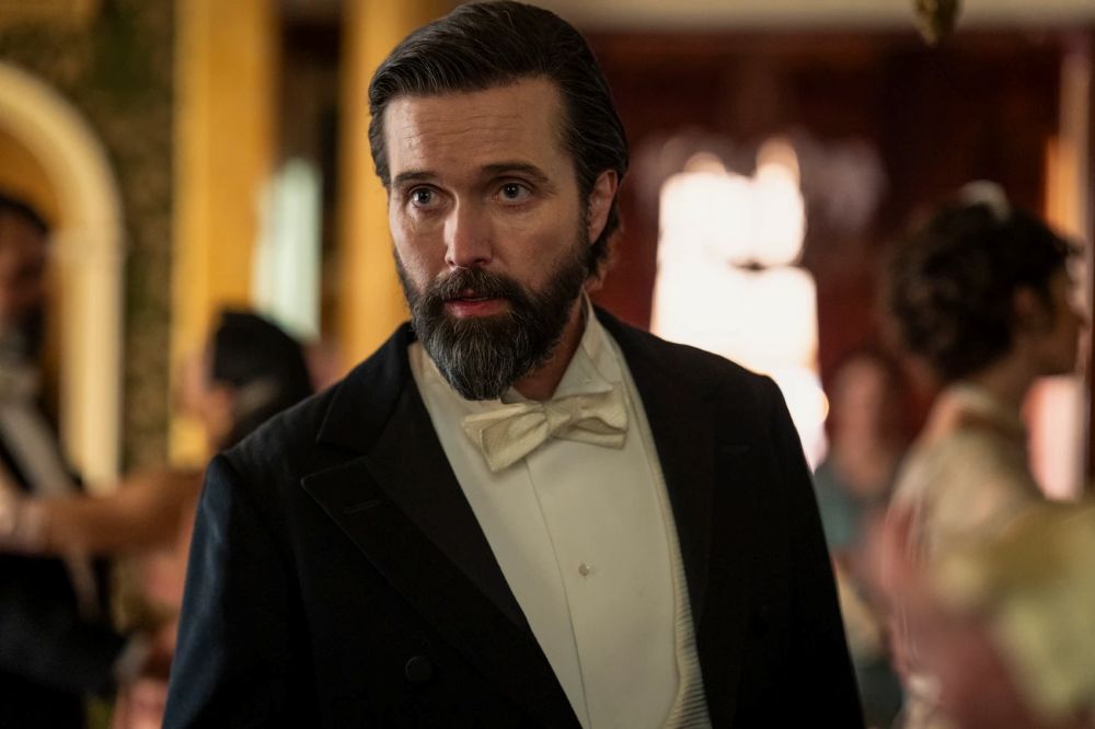 Middle aged man with a beard in a dress suit