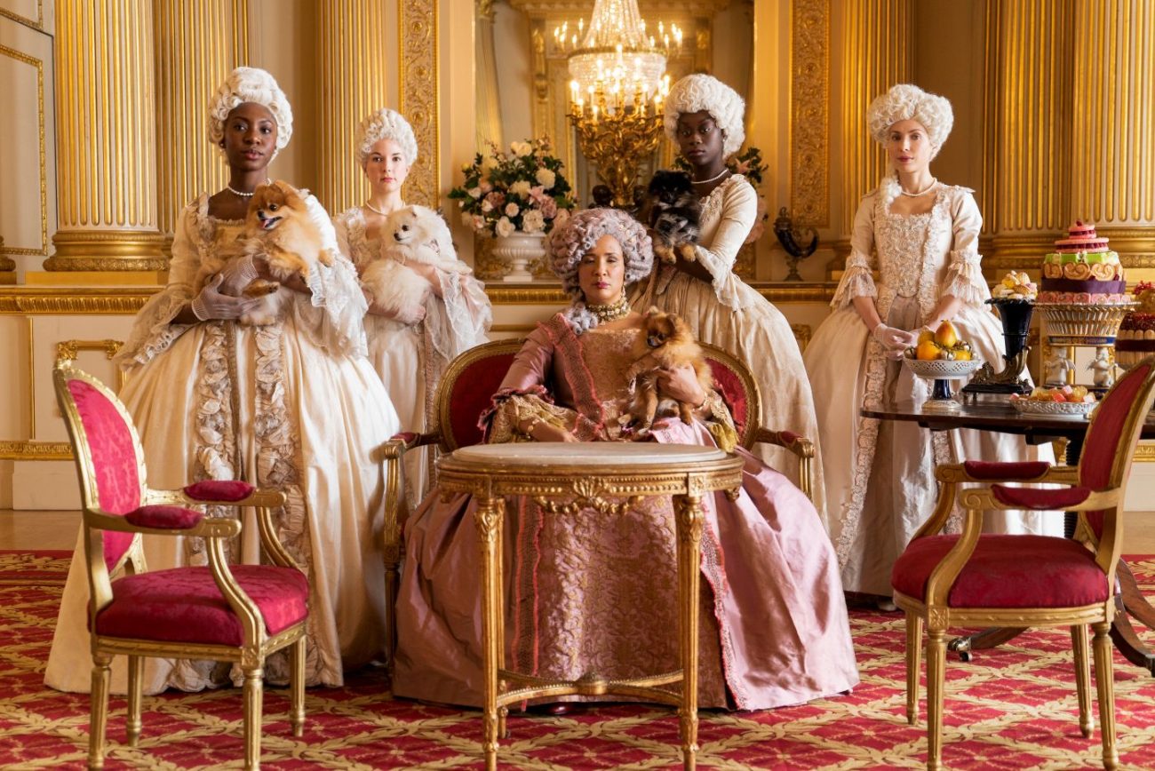 Queen Charlotte surrounded by her ladies and Pomeranian dogs in Bridgerton Season 1 Episode 2