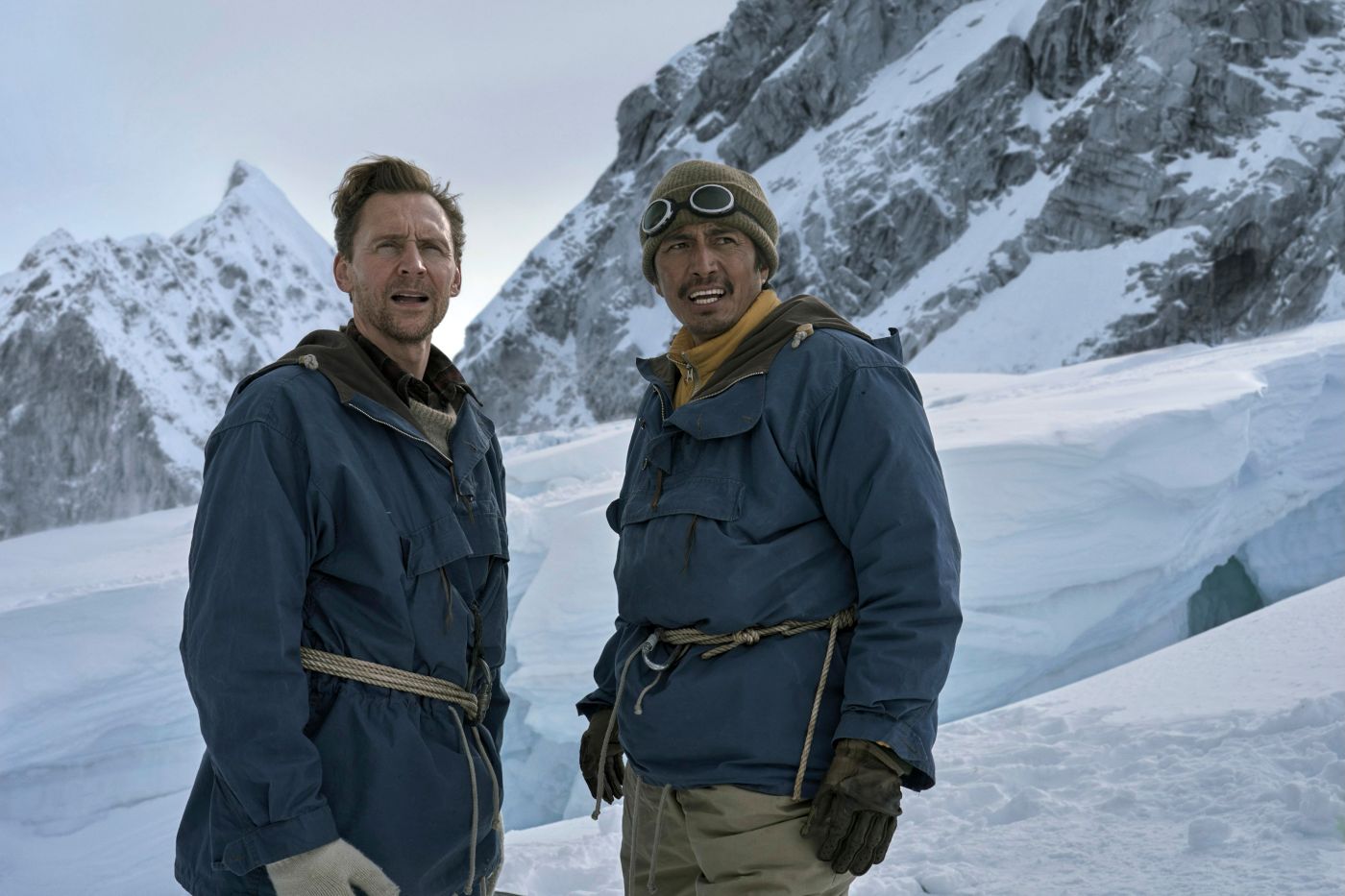 Tom Hiddleston as Edmund Hillary and Genden Phuntsok as Tenzing Norgay on a snowy Himalayan mountain in Tenzing.