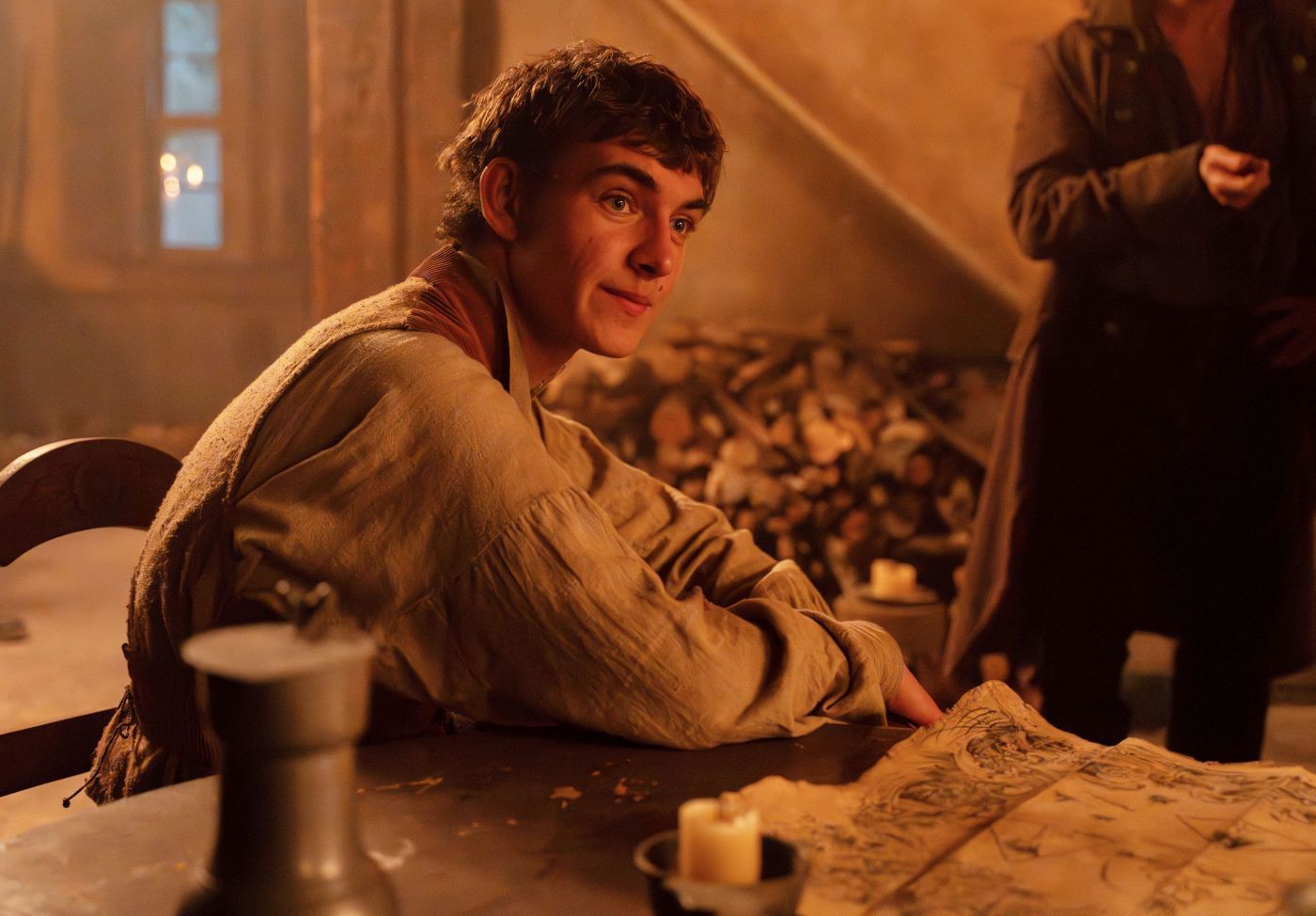 Tom Sweet as Jim Hawkins looking over a treasure map in Treasure Island