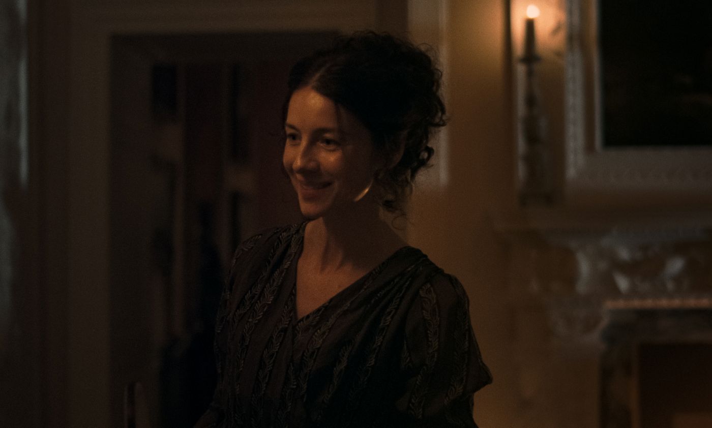 Caitríona Balfe as Mrs Dashwood in a dark dress in Sense and Sensibility.