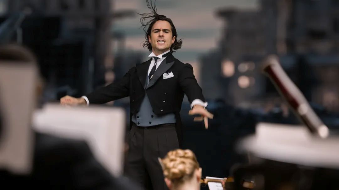 Ben Schnetzer as a young Sergiu Celibidache conducting an orchestra in The Yellow Tie,