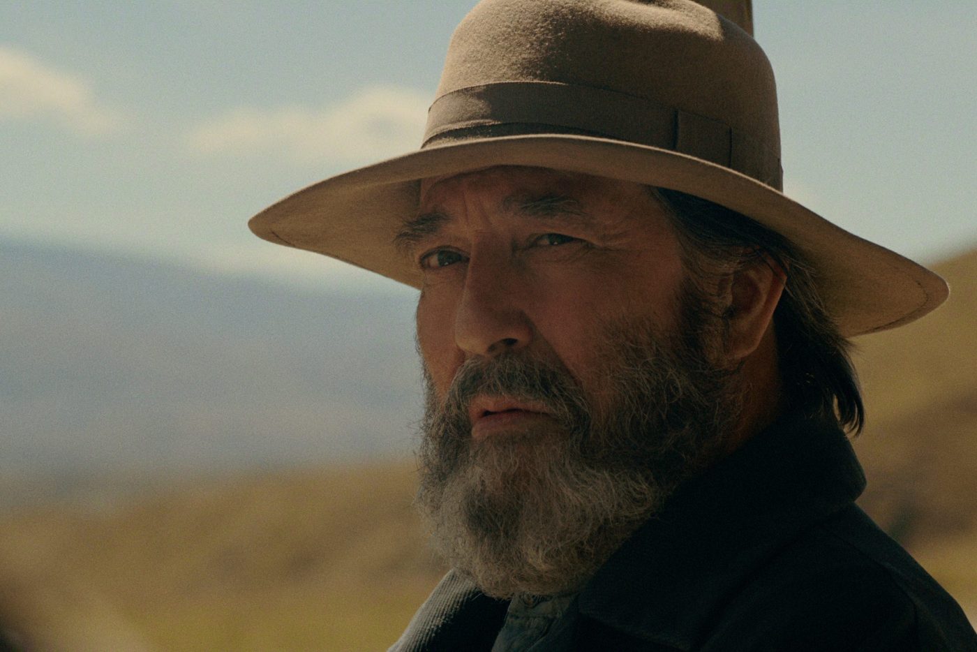 Photo of an old man in the outdoors.