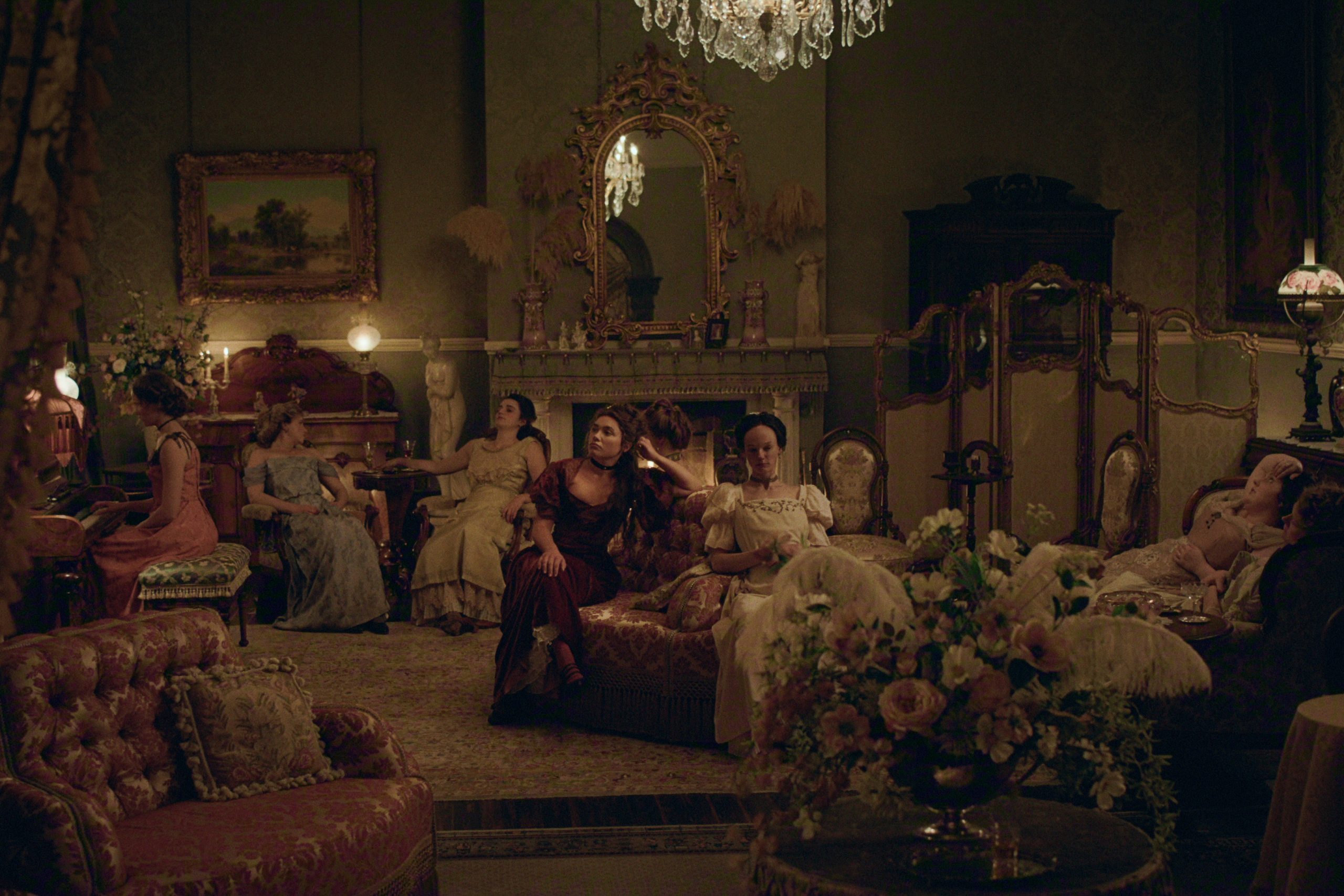 A group of women in the sitting room of a fancy house.