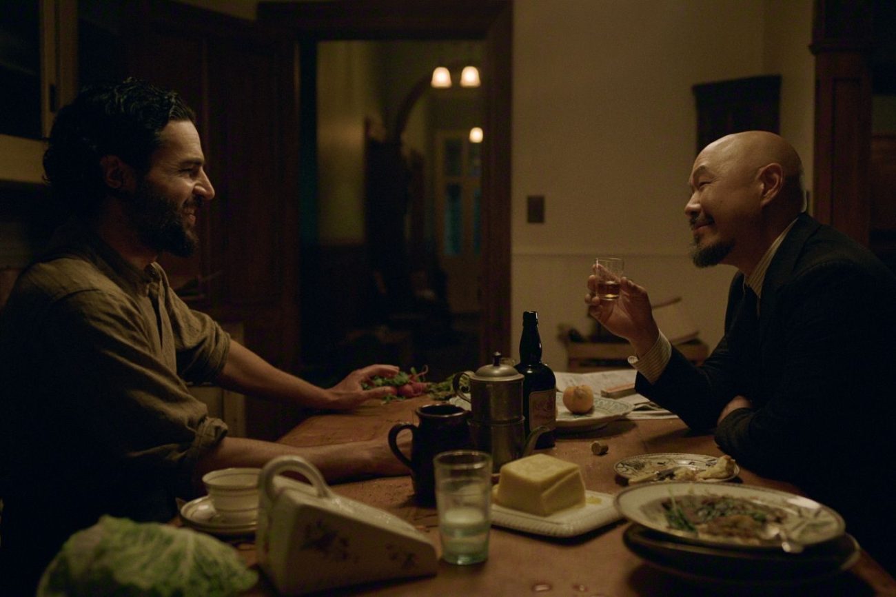 Adam and Lee chat over dinner.