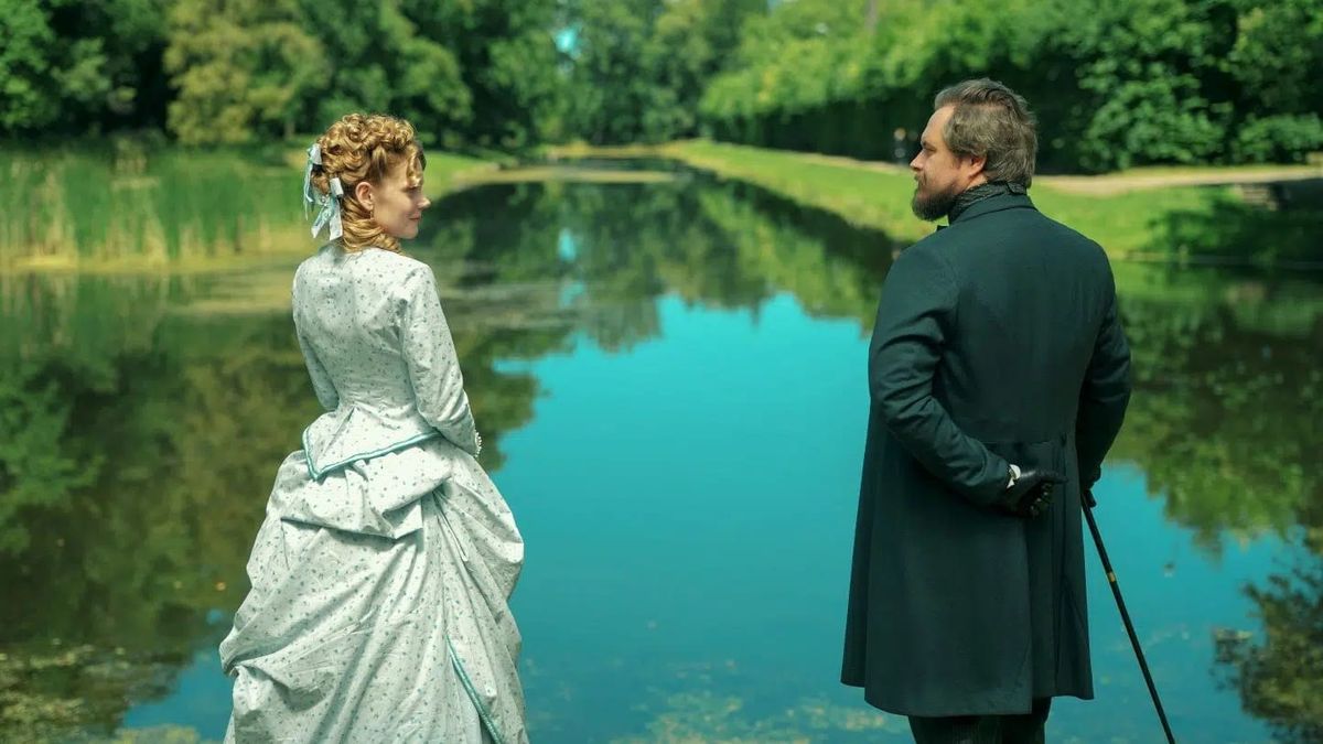 Izabela and Stan stand by a lake in The Doll.