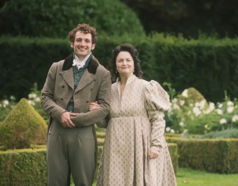 Mr Ryder and Mrs Bennet walk in the garden.
